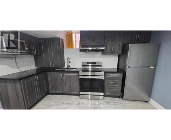 A kitchen with dark wood cabinets and stainless steel appliances.