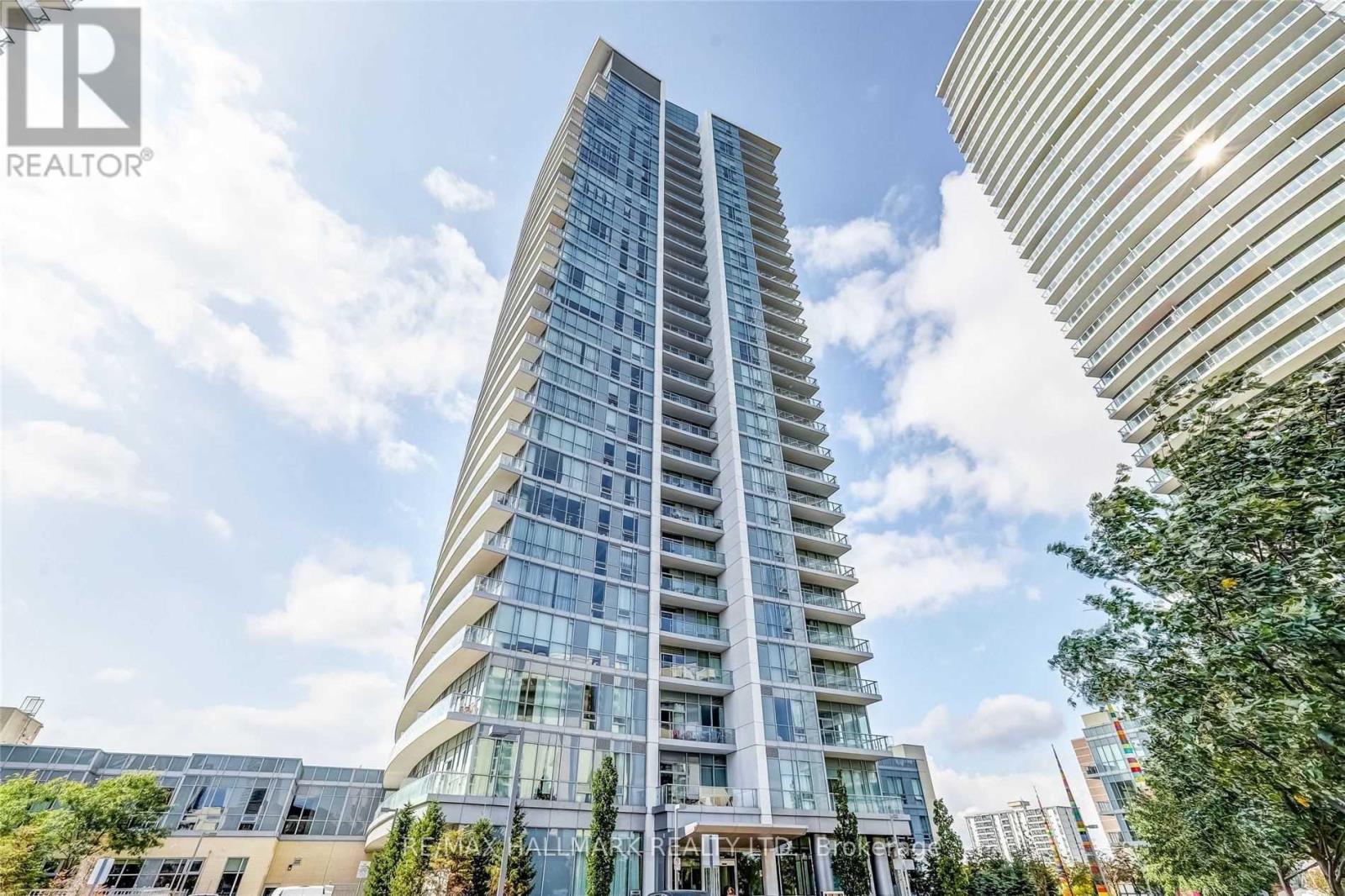 A tall, modern residential building with many windows and balconies is shown.