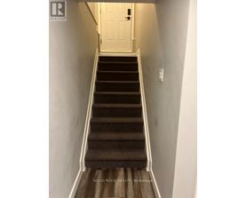 A staircase with a white door at the top.