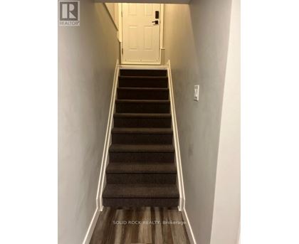 A staircase with a white door at the top.