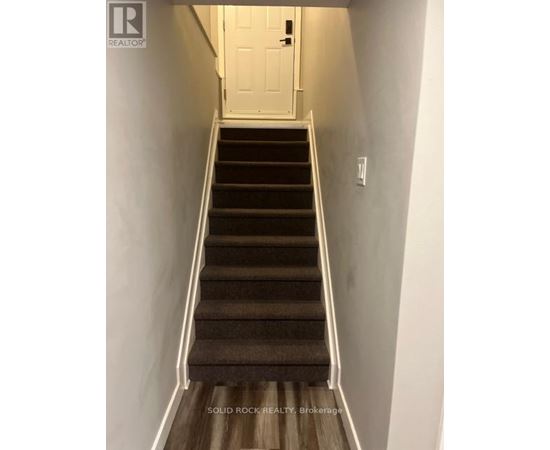 A staircase with a white door at the top.