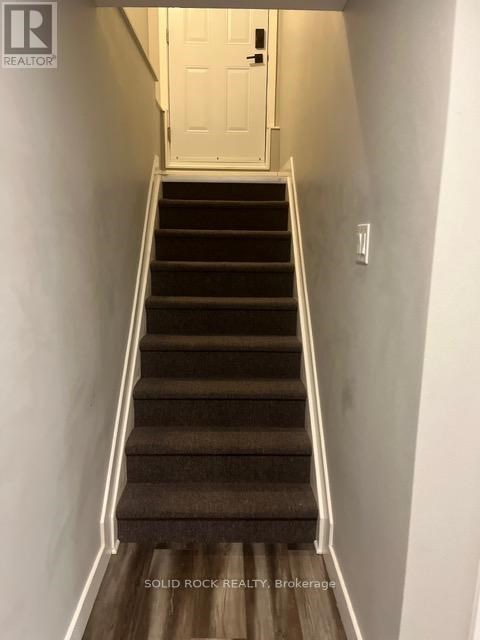 A staircase with a white door at the top.