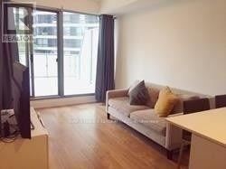 A living room with a couch and a television.
