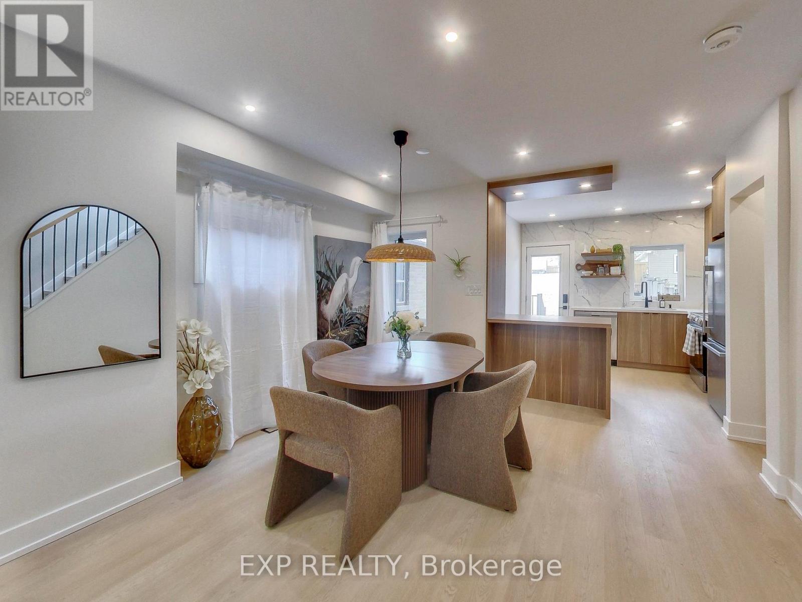 A dining room with a round table and chairs.