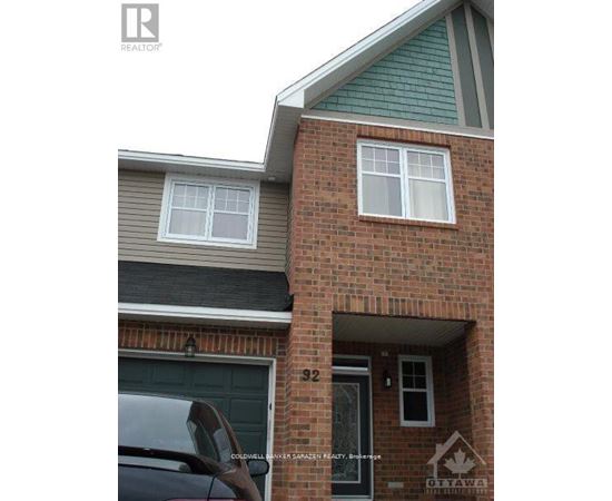 A house with a garage and a car parked in front.