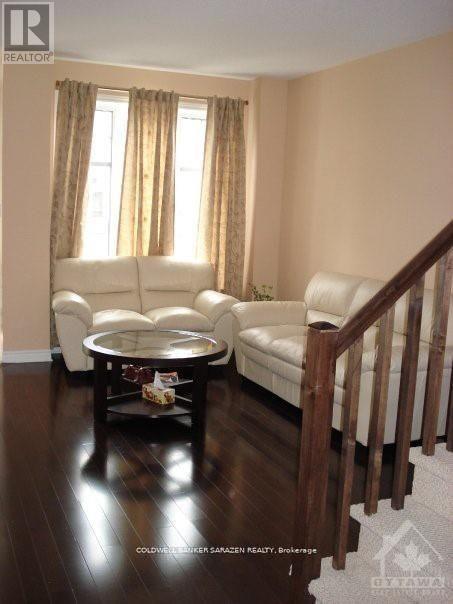 A living room with a white couch and a coffee table.