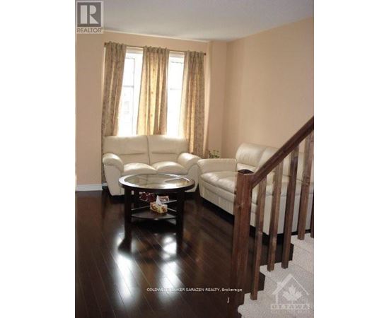 A living room with a white couch and a coffee table.
