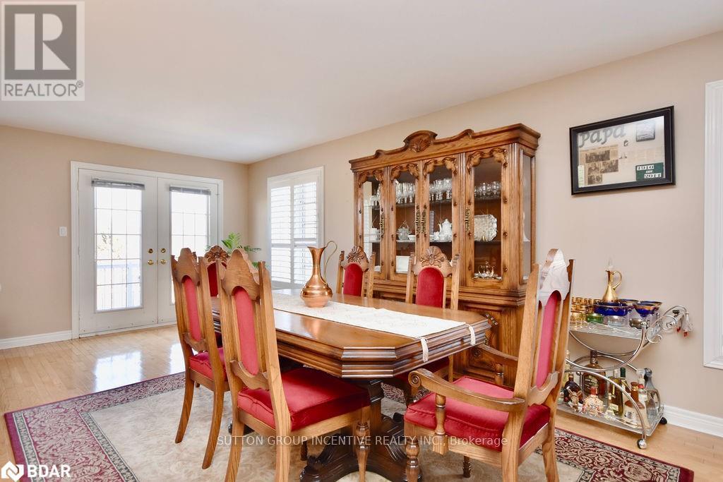 A dining room with a wooden table and chairs.