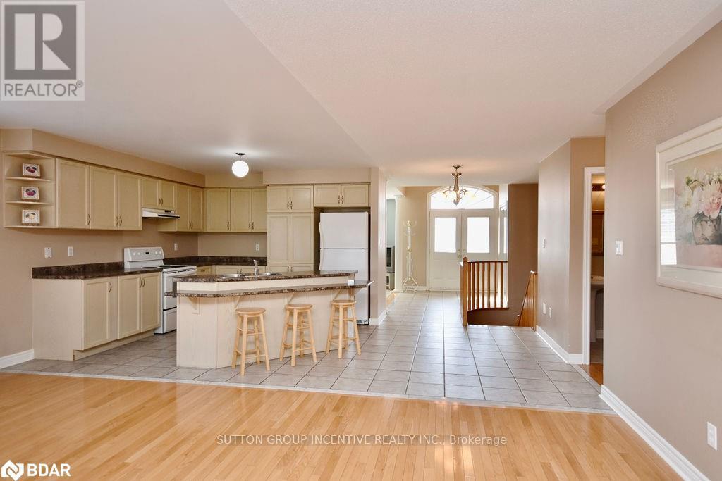 A kitchen with a bar stool in front of it.