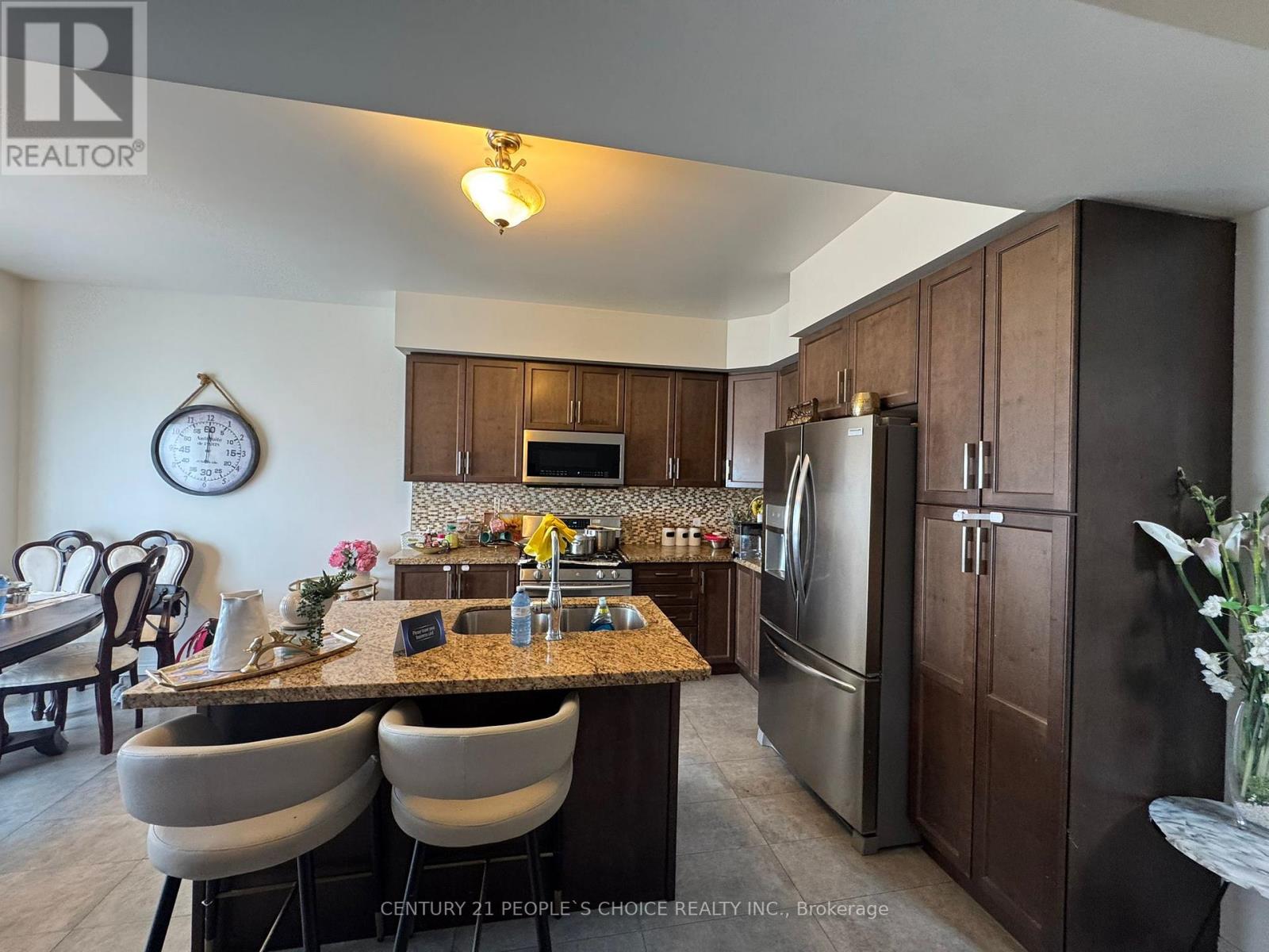 A kitchen with brown cabinets and a granite countertop.
