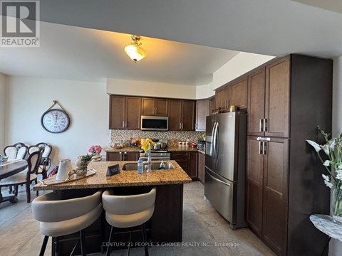 A kitchen with brown cabinets and a granite countertop.