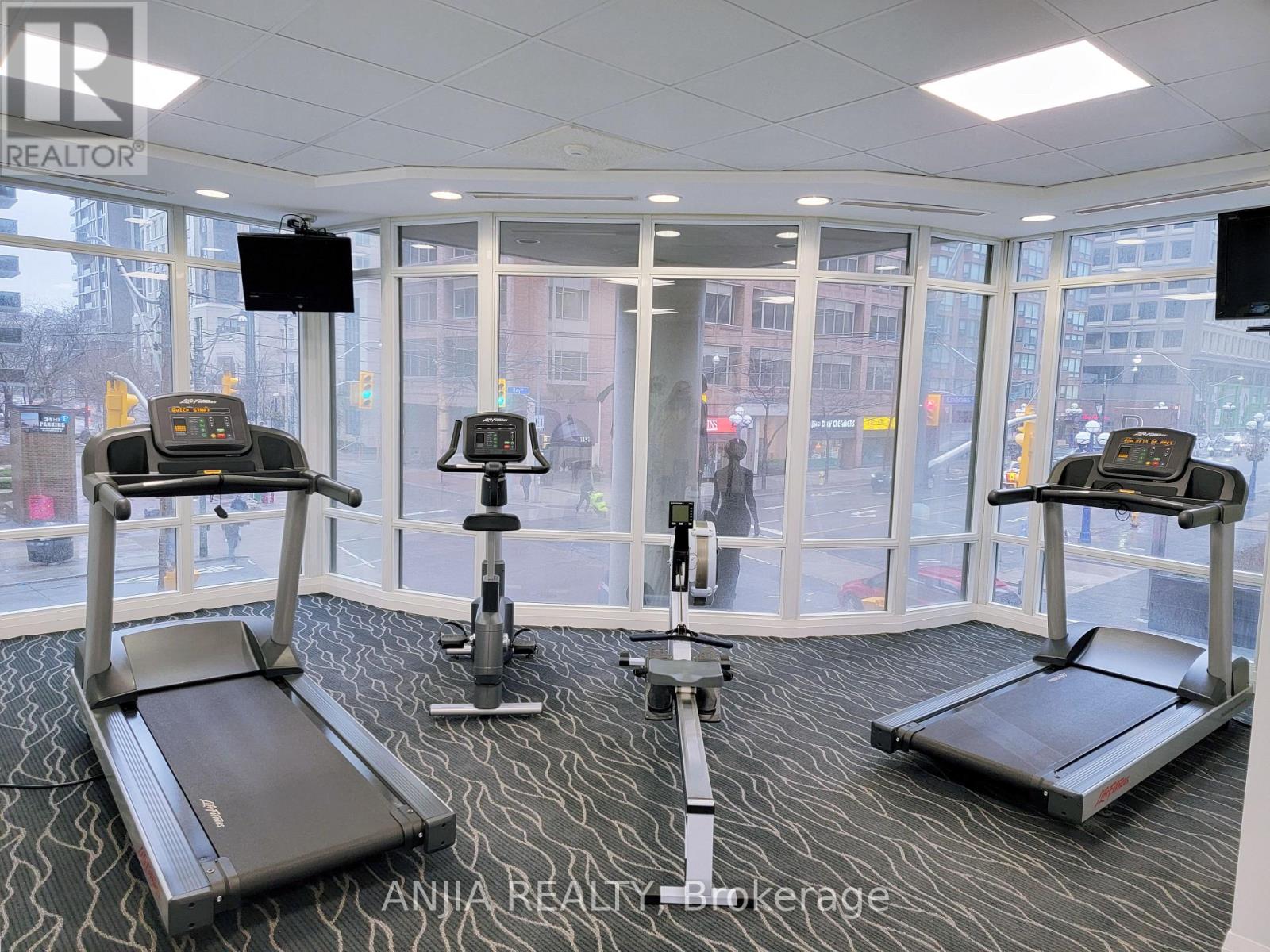 A gym with treadmills and elliptical machines.