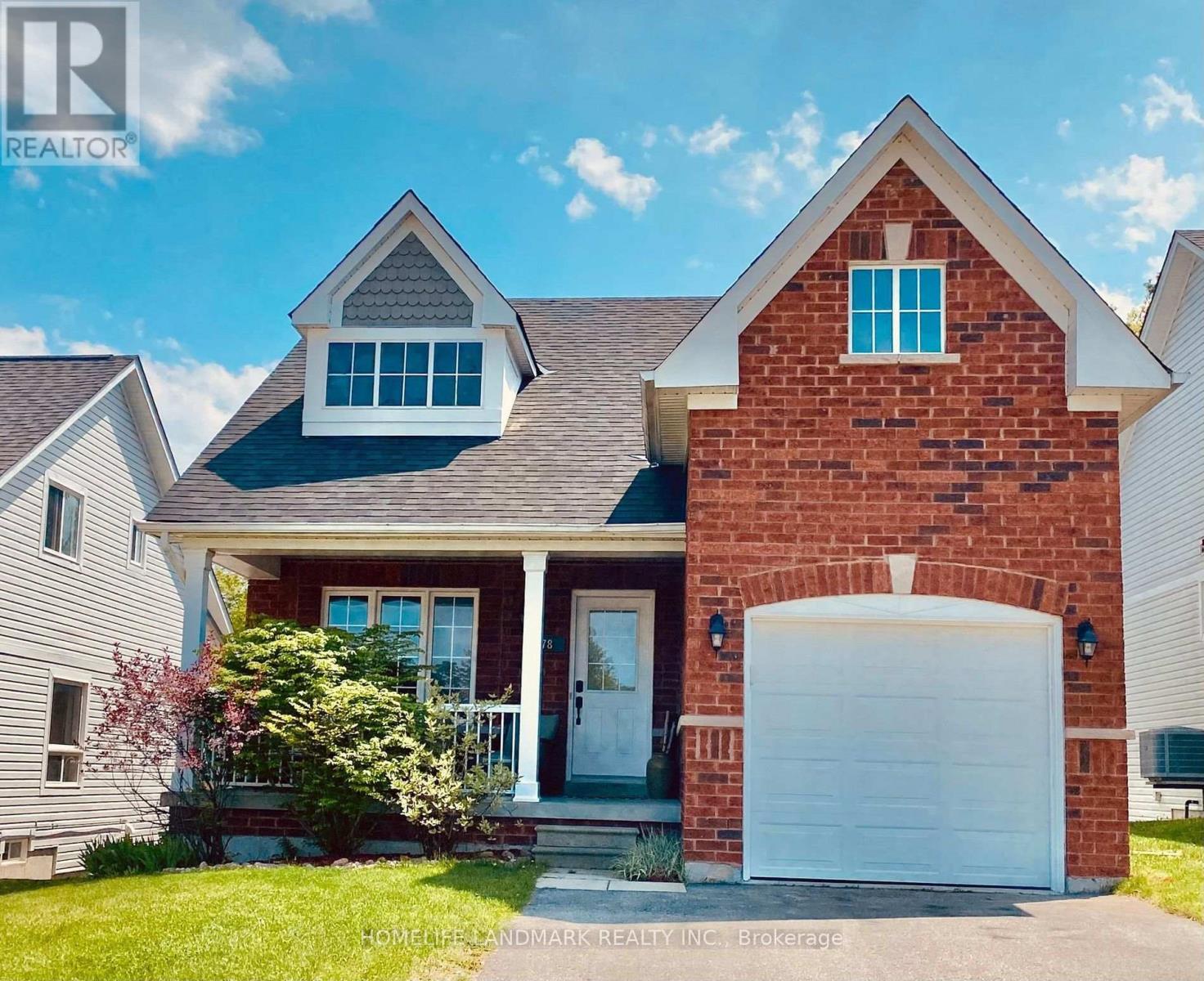 A red brick house with a white garage door and a white door.