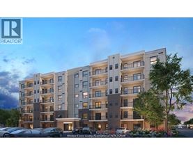 A modern apartment building with a parking lot in front.