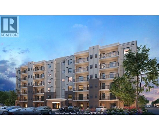 A modern apartment building with a parking lot in front.