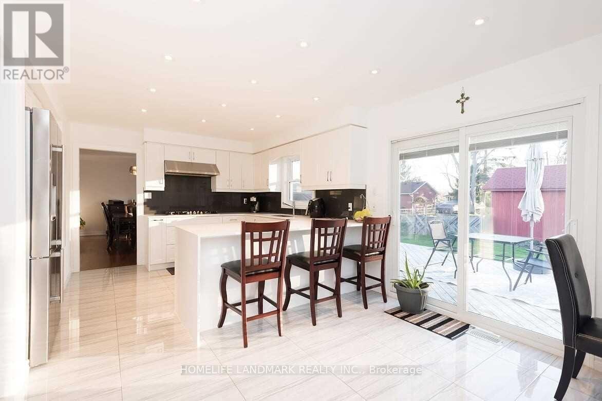 A modern kitchen with a dining table and chairs.