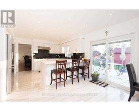 A modern kitchen with a dining table and chairs.