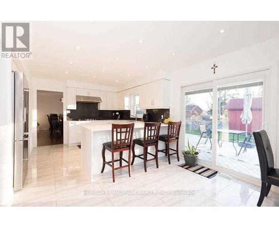 A modern kitchen with a dining table and chairs.