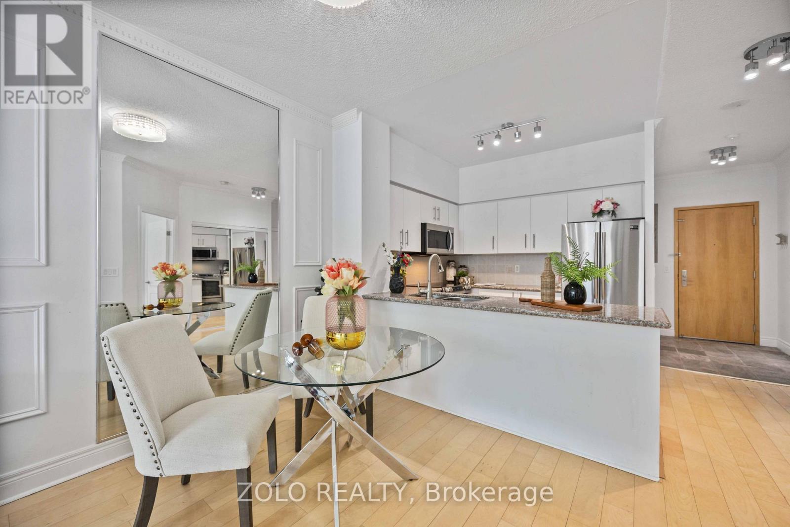 A modern kitchen with a glass table and chairs.
