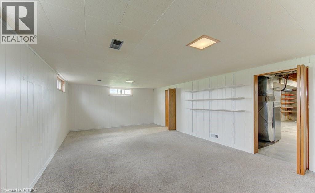 A spacious garage with a white interior and a door open to a construction site.