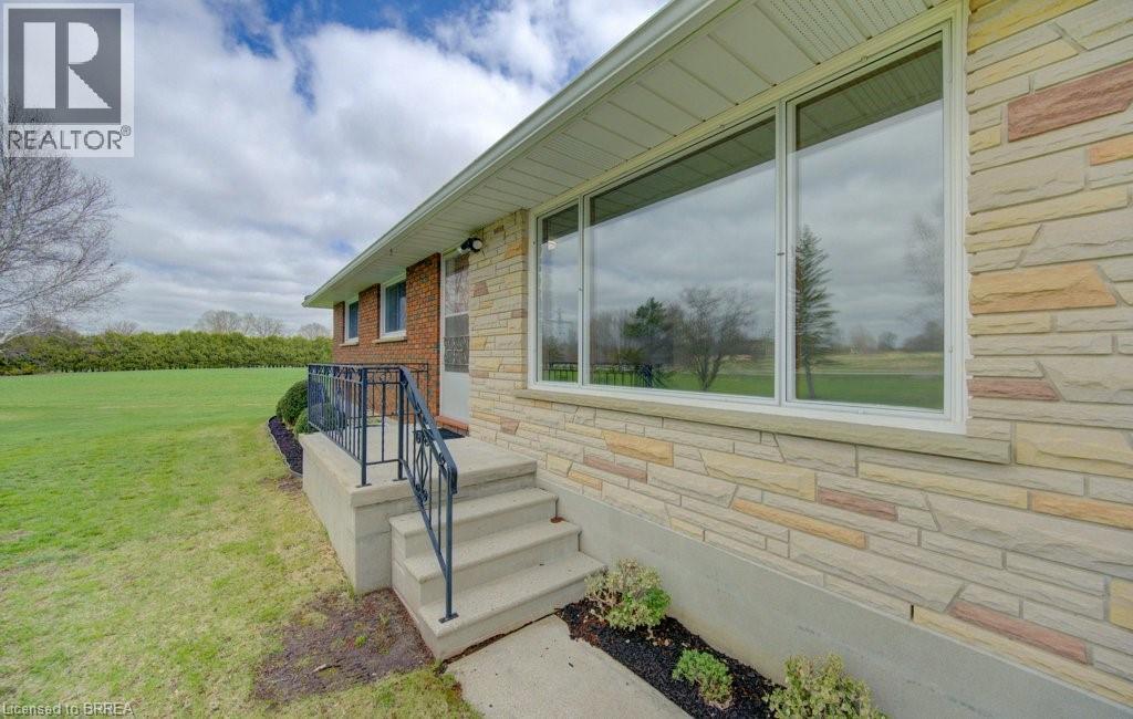 A house with a stone wall and a glass door.