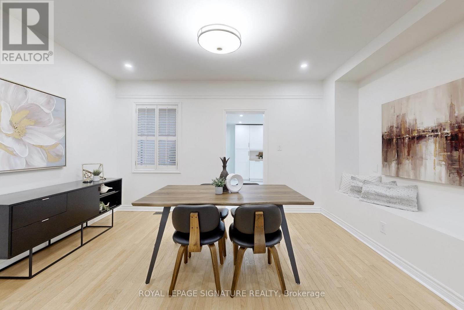 A dining room with a table and chairs.