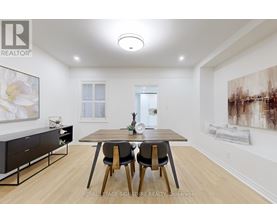 A dining room with a table and chairs.