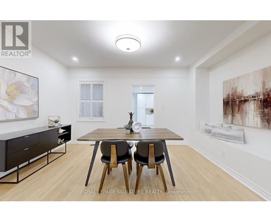 A dining room with a table and chairs.