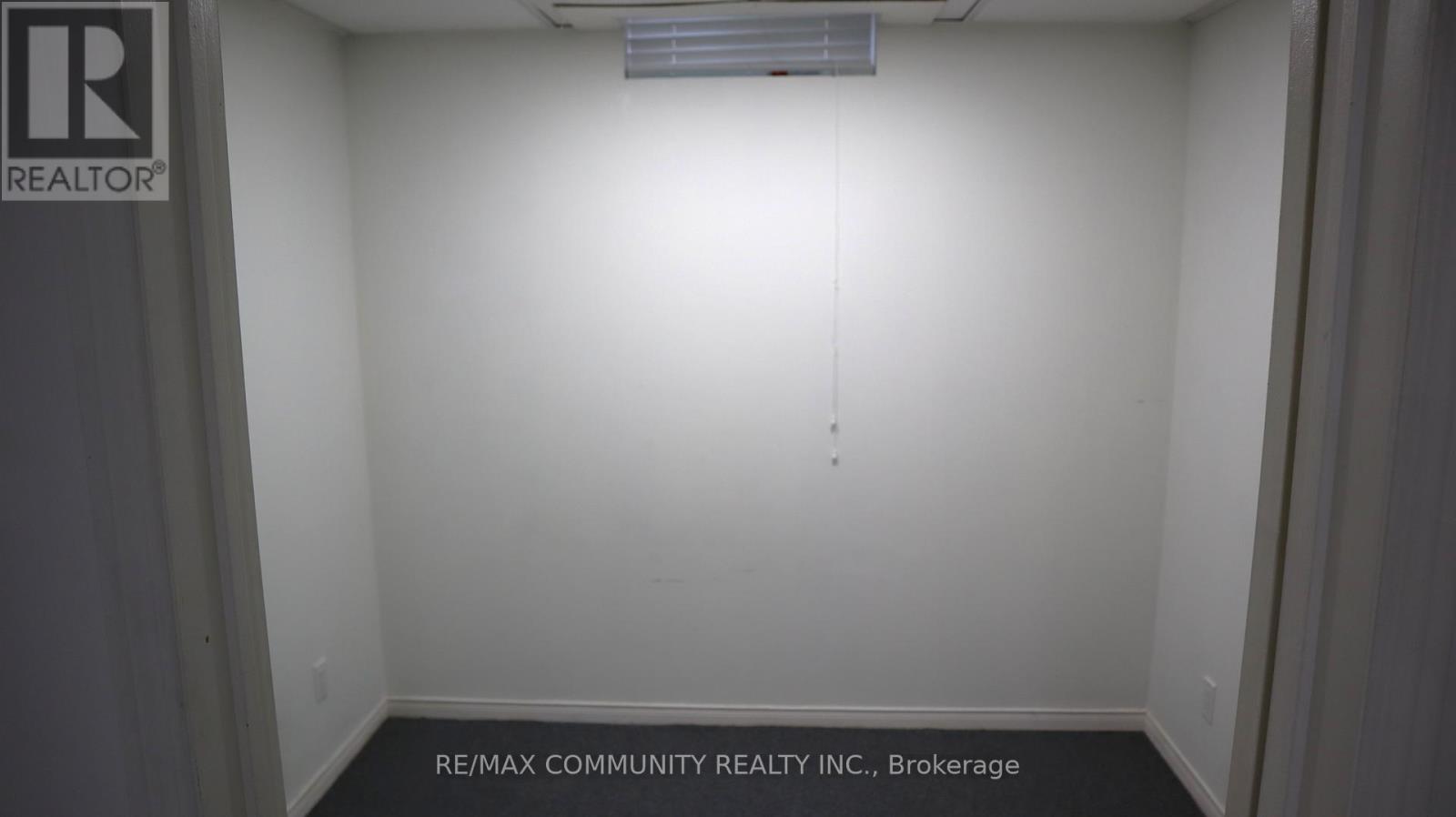 A white room with a sign that says REALTOR.