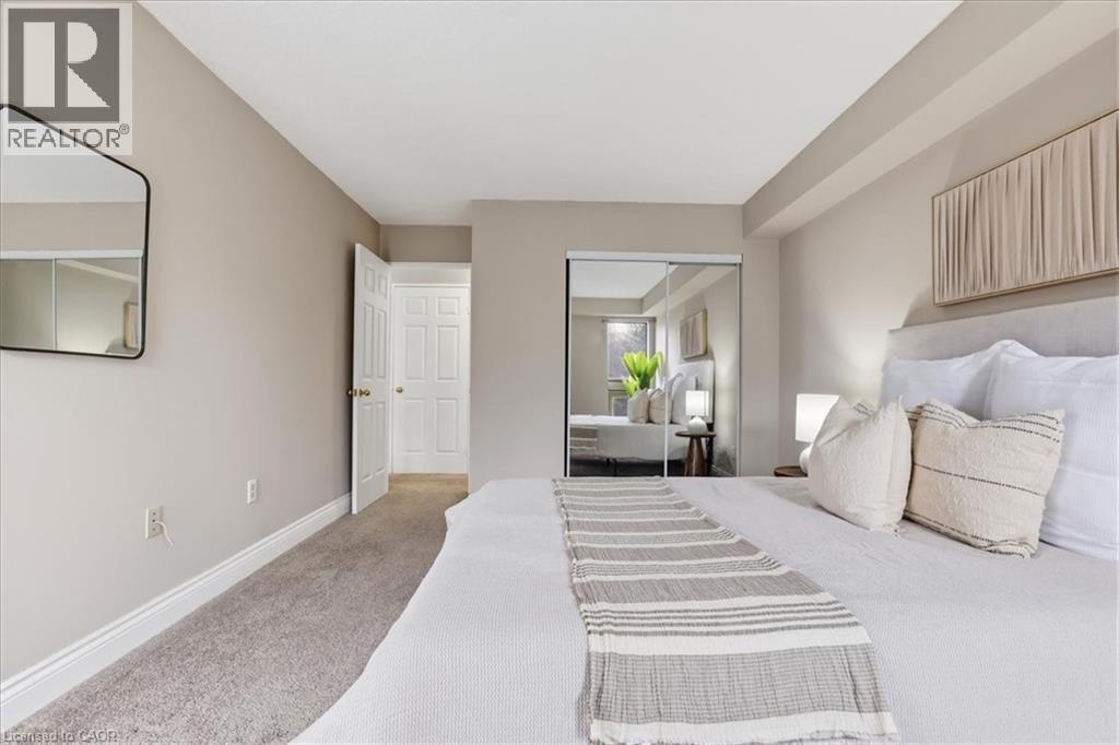 A bedroom with a large bed and a mirror on the wall.
