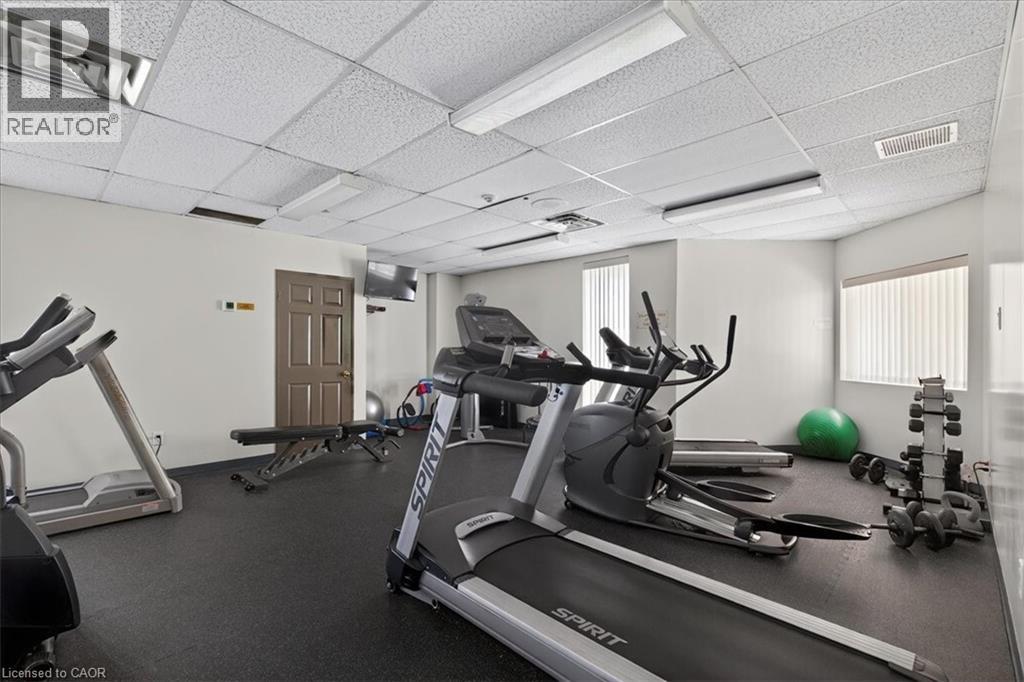 A well-equipped gym with a treadmill, exercise balls, and weights.