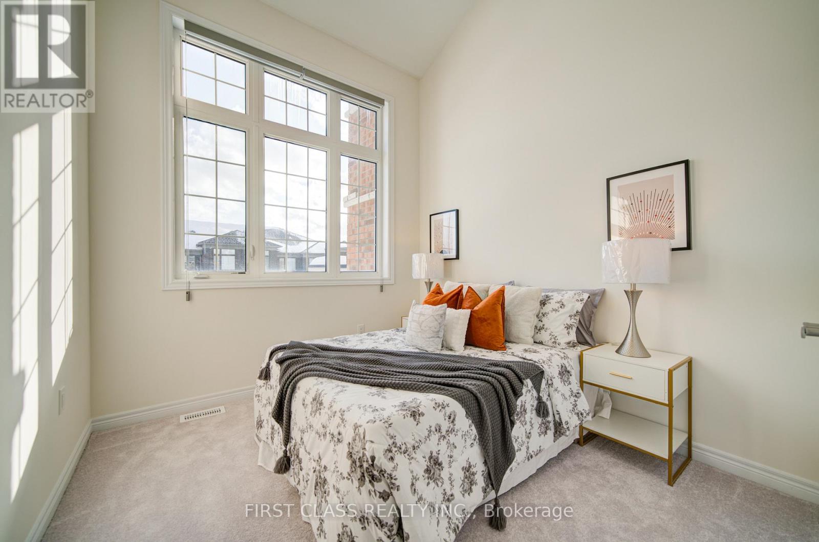 A bedroom with a large bed and a window.