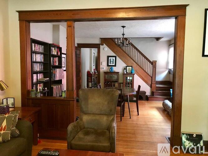 A living room with a chair and a bookcase.