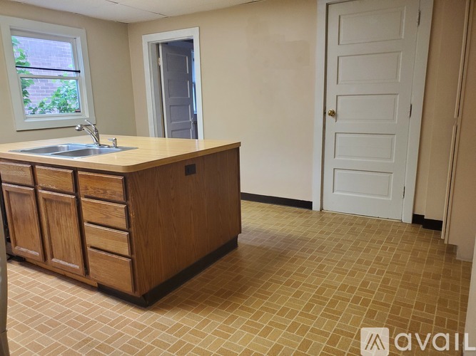 A kitchen with a sink and cabinets.