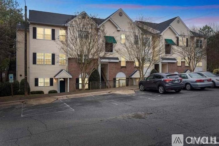 A building with a parking lot in front of it.