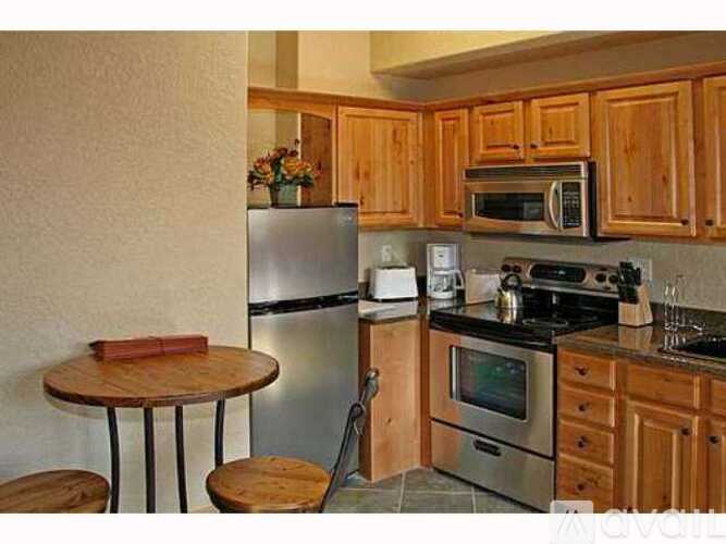 A kitchen with wooden cabinets and stainless steel appliances.