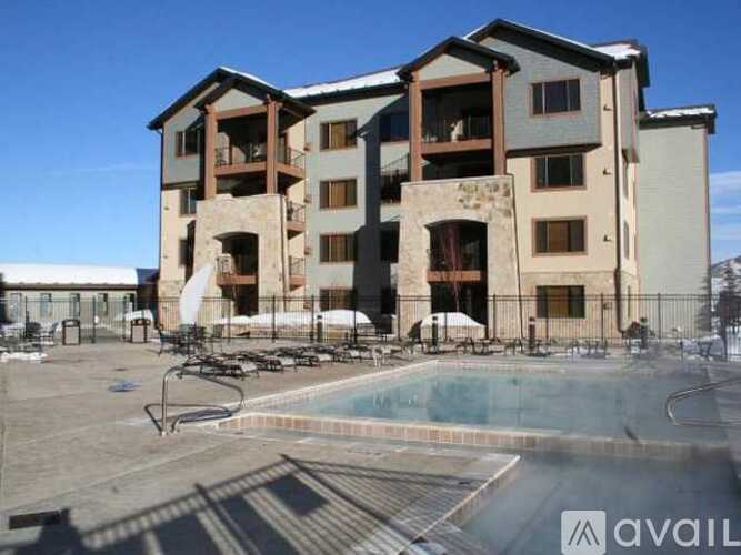 A large building with a pool in front of it.