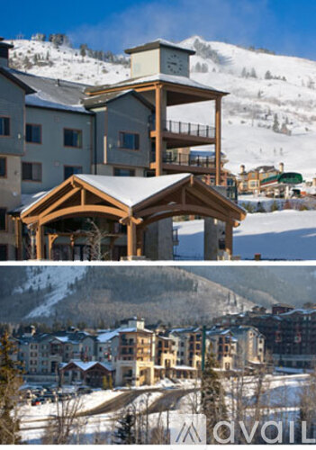 A large wooden building with a balcony in the middle of a snowy mountain.