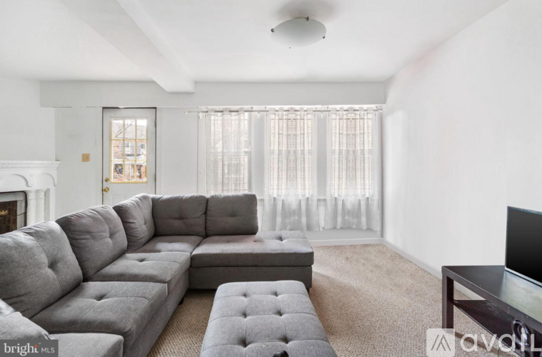 A grey sectional sofa with a coffee table in front of it.