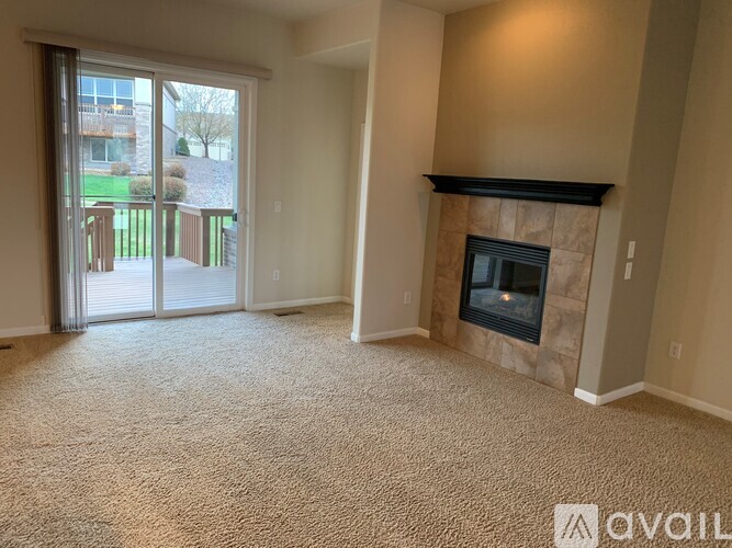 A living room with a fireplace and sliding glass doors.