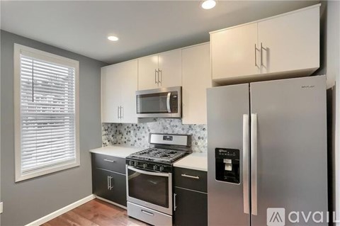 A kitchen with a stove top oven and a refrigerator.
