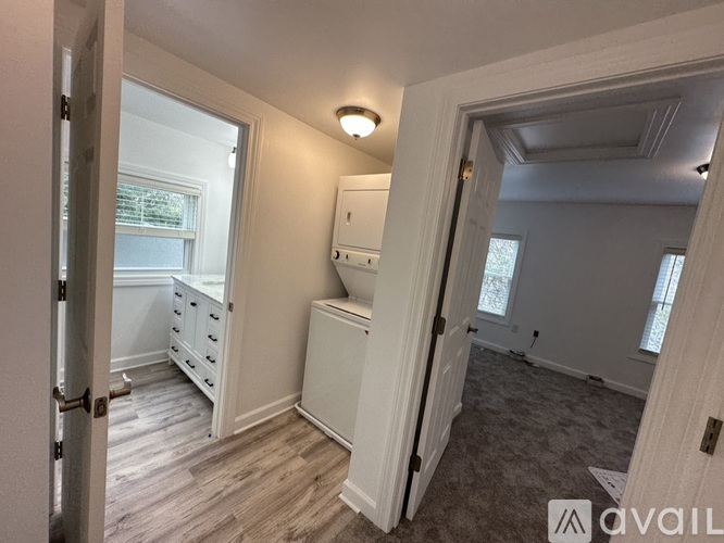 A bedroom with a bed, dresser, and window.