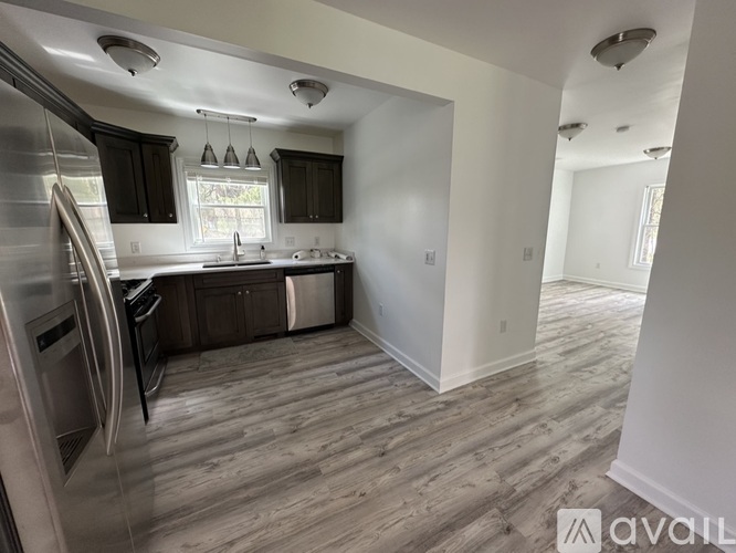 A kitchen with dark wood cabinets and stainless steel appliances.