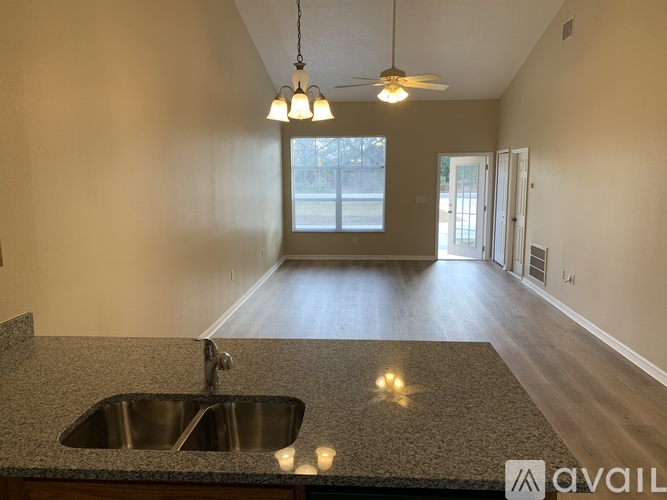 A kitchen with a granite countertop and a sink.