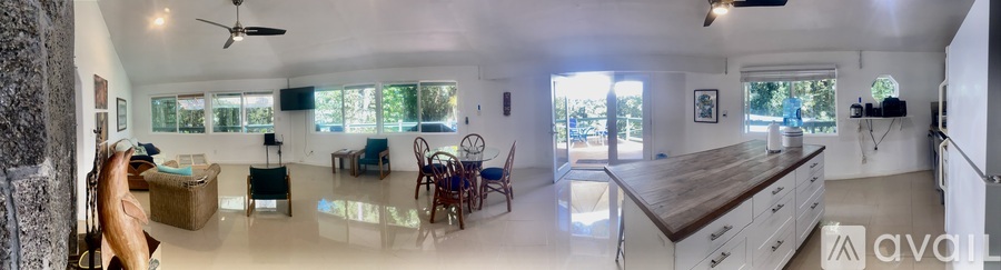 A spacious kitchen with a dining table and chairs.
