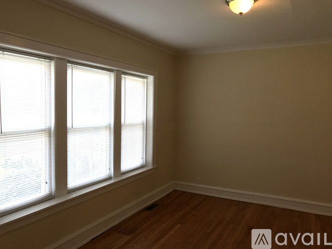 A room with a window and wooden flooring.