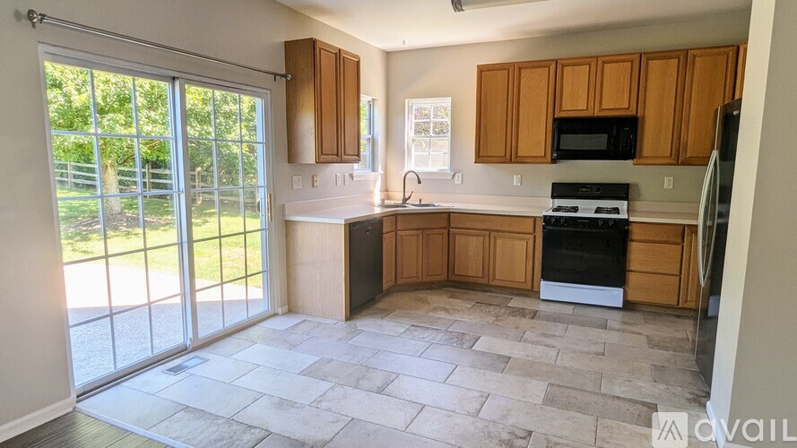 A kitchen with wooden cabinets and a black oven.