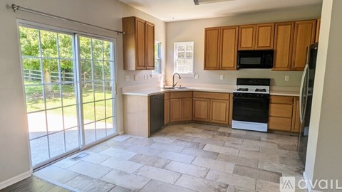 A kitchen with wooden cabinets and a black oven.