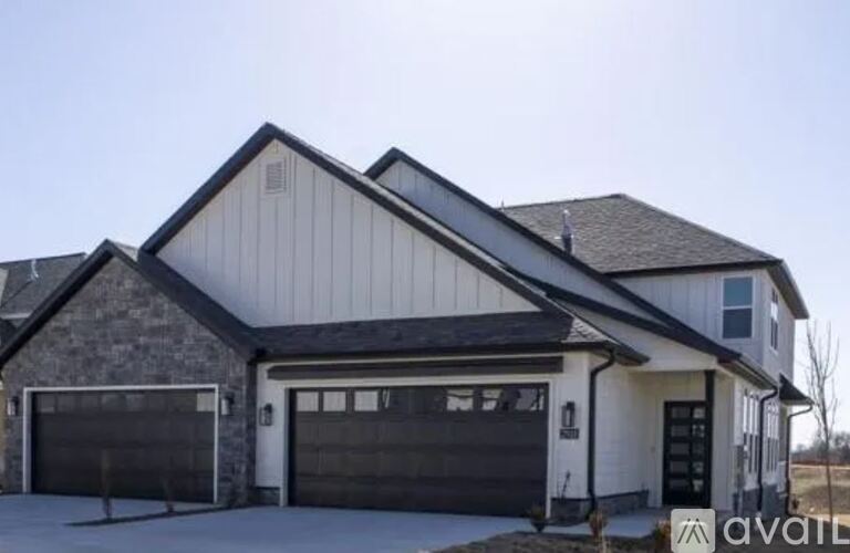 A two-story house with a garage is available for sale.
