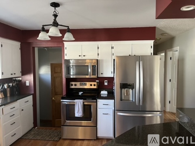 A kitchen with a stainless steel refrigerator and oven.